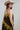 A woman  wearing a chocolate  brown maxi dress with olive green lace trim, styled with a stone/beige cowboy hat and brown boots -Lace_Trim_Maxi_Dress_-_Brown_Chartreuse-FleaStyle