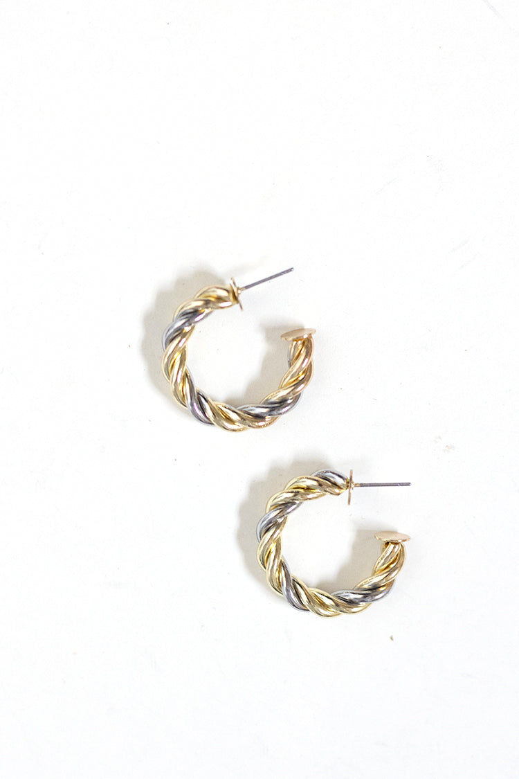 Close-up of mixed metal twisted hoop earrings in gold and silver tones, lightweight everyday jewelry for casual or dressy looks.