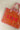 An orange quilted fabric tote bag with a paisley bandana border, pink fringe trim, and the word 'LOVE' embroidered in pink on the front for a casual day out-Love_Bandana_Quilted_Tote_Bag_-_Orange-FleaStyle