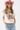 A woman wearing a pink cowboy hat and vintage-inspired graphic tee in a classic, relaxed t-shirt fit in a soft ivory hue with colorful retro-inspired Dolly Parton artwork, and light blue jeans, posing against a white studio background-Dolly_Western_Butterfly_Graphic_T-Shirt-FleaStyle