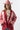 A woman wearing a red paisley jacket featuring an easy, relaxed silhouette with quilted detailing, contrasting stitching and beautiful lace appliqués that give it a cool, collected-over-time feel-Quilted_Jacket_with_Paisley_Patches_-_Red-FleaStyle