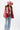 A woman wearing a red paisley jacket featuring an easy, relaxed silhouette with quilted detailing, contrasting stitching and beautiful lace appliqués that give it a cool, collected-over-time feel-Quilted_Jacket_with_Paisley_Patches_-_Red-FleaStyle