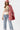 A woman wearing an ivory "Dolly" graphic t-shirt, a pink cowboy hat and a flattering high-rise relaxed wide-leg jean with oversided cuffs for an effortlessly cool look-Super High Rise Cuffed Baggy Straight Jeans-FleaStyle