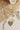 Love Statement Charm Necklace - Gold with shells on a textured surface-Fleastyle