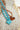 Enamel-Heart-Beaded-Necklace-Tortoiseshell-Fleastyle with a heart-shaped amber pendant on a textured background-Fleastyle
