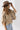 A woman wearing a cropped leopard-print cape-inspired jacket with a relaxed silhouette and a classic collared neckline, paired over a graphic t-shirt and a brown cowboy hat, jeans and cowboy boots-Leopard_Print_Cape_Jacket-FleaStyle