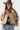 A woman wearing a cropped leopard-print cape-inspired jacket with a relaxed silhouette and a classic collared neckline, paired over a graphic t-shirt and a brown cowboy hat, jeans and cowboy boots-Leopard_Print_Cape_Jacket-FleaStyle