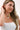 Woman wearing a white top and Sun Charm Scarf Necklace against a plain background- Fleastyle