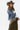 A woman wearing a western-style outfit consisting a silky olive green midi skirt  featuring a flattering bias-cut with lace trim bottom, a denim shacket, a brown cowboy hat, and olive paisley scarf, set against a plain white studio background-Lace_Trim_Satin_Midi_Skirt_-_Olive-FleaStyle