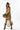A woman wearing a bohemian-style leopard print dress featuring a flowy high-low silhouette, peek-a-boo sleeves, a maroon cowboy hat, and brown cowboy boots, photographed against a solid white background-Animal_Print_High-Low_Chiffon_Dress-FleaStyle
