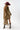 A woman wearing a bohemian-style leopard print dress featuring a flowy high-low silhouette, peek-a-boo sleeves, a maroon cowboy hat, and brown cowboy boots, photographed against a solid white background-Animal_Print_High-Low_Chiffon_Dress-FleaStyle