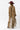 A woman wearing a bohemian-style leopard print dress featuring a flowy high-low silhouette, peek-a-boo sleeves, a maroon cowboy hat, and brown cowboy boots, photographed against a solid white background-Animal_Print_High-Low_Chiffon_Dress-FleaStyle