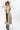A smiling woman wearing a brown cowboy hat, a beige sleeveless vest with robe tie and oversized faux-fur collar, jeans and a white long-sleeve top, photographed against a clean white studio background-Fur Trimmed Sleeveless Duster Vest - Taupe