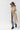 A smiling woman wearing a brown cowboy hat, a beige sleeveless vest with robe tie and oversized faux-fur collar, jeans and a white long-sleeve top, photographed against a clean white studio background-Fur Trimmed Sleeveless Duster Vest - Taupe