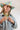 Woman wearing a Chunky Beaded Choker Necklace - Chartreuse, painted colorful cowboy hat and denim jacket with a plain background-Fleastyle