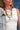 Woman wearing a Bandana_Charm_Necklace_-_Red_Gold-Fleastyle with a denim jacket and white top-Fleastyle