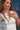 Woman wearing multiple necklaces Bandana-Charm-Necklace-Navy_Gold-Fleastyle standing in front of a denim background-Fleastyle