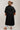 A woman wearing a pintuck shirt dress features a collared neckline, button-front design, defined tie waist and a flowy midi silhouette with a brown straw cowboy hat, a rust-brown ruffled blouseand light-wash blue jeans-Pintuck Waist Tie Front Midi Dress/Duster - Black