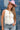 Woman wearing a white tank top, blue jeans , and pink painted cowboy hat with a Medallion Pendant Curb Chain Necklace - Gold standing against a denim background-Fleastyle