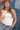 Woman wearing a white tank top, blue jeans, a pink painted cowboy hat with a Chain Wrap Necklace-Gold against a denim patchwork background-Fleastyle