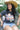 Woman wearing a camel cowboy hat and Choosin_Texas-Graphic-T-Shirt-Yellow in a chair-Fleastyle