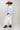 A model wearing a light blue knit short-sleeve top, modern barrel-leg silhouette, adjustable drawstring waist and utility-inspired seaming for a relaxed yet elevated fit, a brown straw cowboy hat, and blue boots--Drawstring_Barrel_Jogger_Pants_-_Ivory-FleaStyle