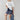A woman wearing a relaxed, boxy fit cropped tee with a baby blue heart graphic that reads 'Howdy Wild & Free' , paired with dark paisley patterened denim shorts and a wide-brimmed dusty blue cowboy hat-Howdy_Heart_Western_Motif_Graphic_T-Shirt-FleaStyle