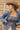 A woman wearing a strapless blue corset-style top with gold-tone buckle clasps, a long satin maxi skirt with a colorful printed  horse design, paired with a beige cowboy hat and dark blue boots, against studio background-Western_Buckle_Strapless_Top_-_Dusty_Blue-FleaStyle