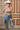 A woman wearing  an ivory cowboy hat, and wide-leg patterned pants and a form-fitting tank featuring a flattering scoop neckline with studded detailing for a subtle western edge-Studded Knit Tank Top - Tan-FleaStyle
