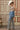 A woman wearing  an ivory cowboy hat, and wide-leg patterned pants and a form-fitting tank featuring a flattering scoop neckline with studded detailing for a subtle western edge-Studded Knit Tank Top - Tan-FleaStyle