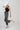 A woman wearing a black studded tank, easy barrel-leg silhouette leopard print jean, silver cowboy boots, and an ivory cowboy hat-Leopard_Print_Barrel_Jeans-FleaStyle