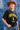 A woman wearing a black graphic t-shirt with yellow 'FORT WORTH TEXAS' lettering, paired with denim shorts, a rust cowboy hat, and brown cowboy boots, standing in front of a blue denim patchwork backdrop-Fleastyle.