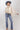 A woman wearing a cream blouse with dark polka dots, mid-rise cropped jeans with a silhouette fit through the hips and thighs and easy kick flare, and a dusty  blue cowboy hat-Mid-Rise_Cropped_Bootcut_Jeans-FleaStyle.