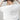 A woman wearing a white short-sleeve crop top with a lace sheer underlay in a delicate floral pattern, with fitted silhouette and thumb holes, blue jeans, and a dusty blue cowboy hat -Lace_Mock_Neck_Sheer_Underlay_-_Beige-FleaStyle