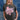 Woman in a trucker hat, Choosin' Texas Graphic T-Shirt - Pink- denim shorts and cowboy boots in front of a denim patchwork background-Fleastyle