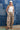 Woman in a Ruched_Wide_Leg_Star_Print_Pant with adjustable ankle ties, and red cowboy boots-Fleastyle