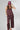 A woman wearing a burgundy strapless top and matching bottoms with a pink polka dot pattern, wearing a  baseball cap with "92651 LAGUNA BEACH" logo, and a pink beaded necklace with a gold star pendant-FleaStyle-Polka Dot Wide Leg Pants - Burgundy/Pink-Fleastyle