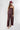 A woman wearing a burgundy strapless top and matching bottoms with a pink polka dot pattern, wearing a  baseball cap with "92651 LAGUNA BEACH" logo, and a pink beaded necklace with a gold star pendant-FleaStyle-Polka Dot Wide Leg Pants - Burgundy/Pink-Fleastyle