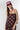 A woman modeling a burgundy strapless top and matching bottoms with a pink polka dot pattern, wearing a  baseball cap with "92651 LAGUNA BEACH" logo, and a pink beaded necklace with a gold star pendant-FleaStyle