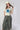 A woman  wearing a cream t-shirt with a large blue star applique, Washed Camo Pants with Ruched Ankle, an ivory cowboy hat-Denim Star Short Sleeve Graphic T-Shirt - Ivory-FleaStyle