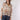 A woman wearing an ivory cowboy hat and a long-sleeve, balloon-silhouette blouse with a colorful paisley and floral print, paired with dark denim shorts-Button Down Paisley Printed Blouse - Pink/Orange