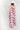 Woman wearing a Monstera-Leaf-Print-Halter-Maxi-Dress-Pink and a Brooks Straw Cowbowy Hat White-FleaStyle