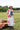 Woman sitting outdoors in a field wearing Lenny Wool Short-Brim Hat - Blush-Fleastyle