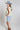 Woman wearing a floral top, High-Rise-Raw-Hem-Midi-Denim-Short and a wide-brimmed dusty blue cowboy hat-FleaStyle