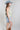 Woman wearing a floral top, High-Rise-Raw-Hem-Midi-Denim-Short and a wide-brimmed dusty blue cowboy hat-FleaStyle