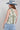 Woman wearing a floral top, High-Rise-Raw-Hem-Midi-Denim-Short and a wide-brimmed dusty blue cowboy hat-FleaStyle