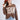 Woman wearing a brown chunky 'TEXAS' sweater and rust cowboy hat and jeans-FleaStyle