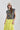 Woman wearing a You-Shook-Me-All-Night-Long-Boxy-Muscle-Tee and lime striped skirt with a beige trucker cap-Fleastyle