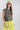 Woman wearing a You-Shook-Me-All-Night-Long-Boxy-Muscle-Tee and lime striped skirt with a beige trucker cap-Fleastyle