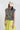 Woman wearing a You-Shook-Me-All-Night-Long-Boxy-Muscle-Tee and lime striped skirt with a beige trucker cap-Fleastyle